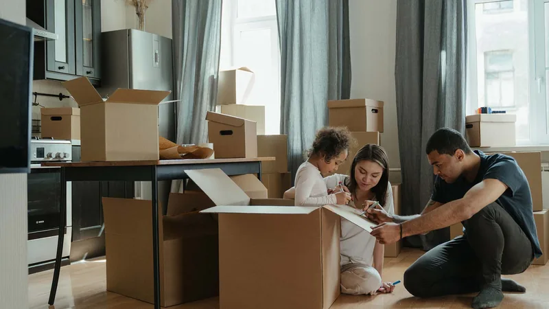 A family unpacking boxes in their new home